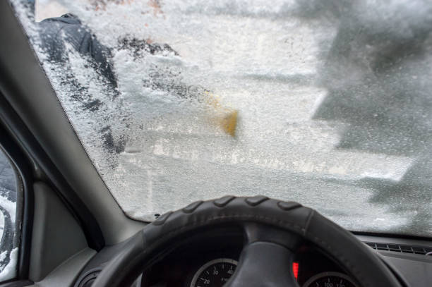 istock snow on windshield, snow cleaning, car in winter conditions 1090961514
