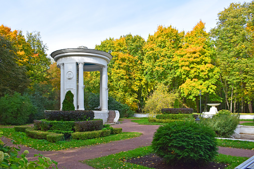 Flowers in the garden park of Belvedere in Weimar, Germany\nA beautiful country house with a vibrant flower garden in full bloom under a clear blue sky, depicting rural tranquility.