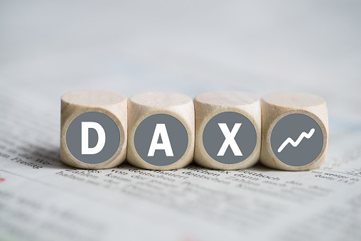 cubes forming the acronym DAX on a newspaper