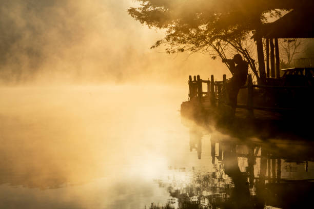 Photographer silhouette at sunrise.