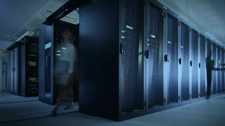 Time Lapse Footage of IT Employees Working in a Data Center Server Room. Technicians and Engineers Running Diagnostics and Maintenance, Inspecting Server Racks.