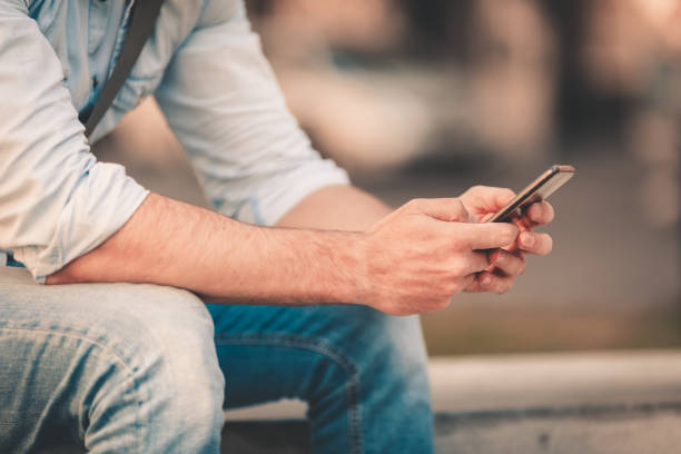 istock Smiling man texting on the street 1090968606