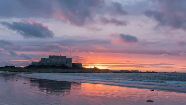 Photo of Sunset on the beach and Fort National during low tide in Saint Malo