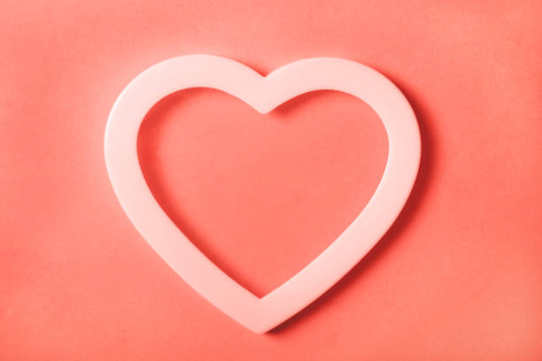istock Heart with shadow on coral background. 1090969140