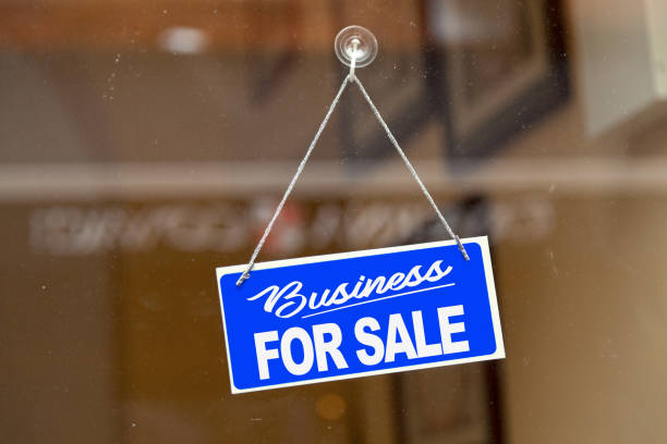 Business for sale - For sale sign Blue sign hanging at the glass door of a shop saying: "Business for sale". for sale sign photos stock pictures, royalty-free photos & images