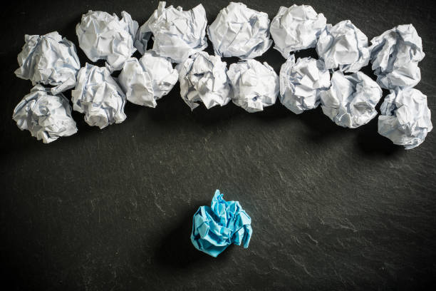 istock crumpled paper symbolizing different solutions with one standing out with a different color on slate background 1090972748