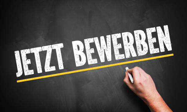 istock hand writing 'Apply Now!' in German on a chalkboard 1090974636