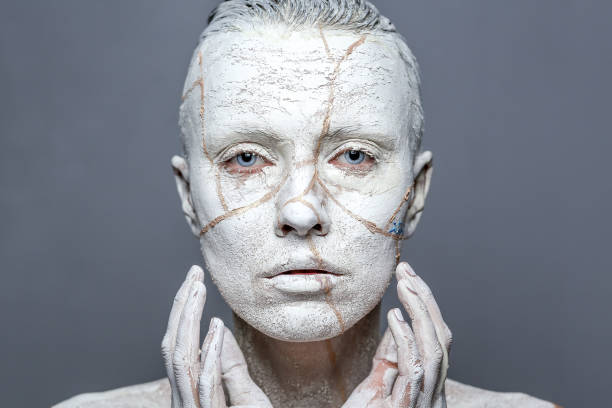 istock Beautiful woman with clay on face 1090975280