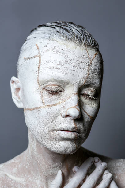 istock Art portrait of woman covered in clay 1090975310