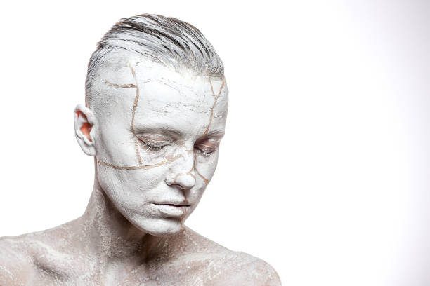 istock Beautiful woman with clay on face 1090975382