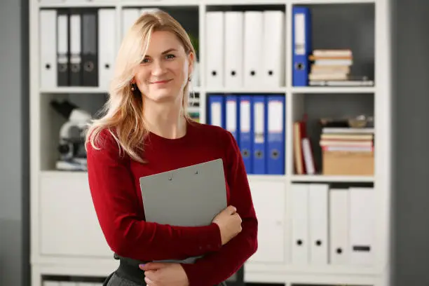 Photo of Happy smiling blond businesswoman holdig