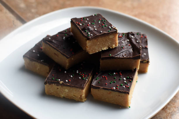 Plate of homemade chocolate peanut butter squares with holiday sprinkles stock photo