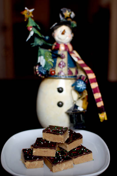 Plate of homemade chocolate peanut butter squares with holiday sprinkles stock photo