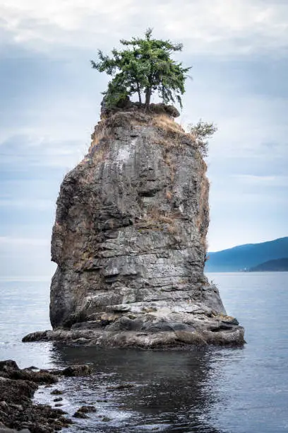 The Siwash Rock, also called the Nine Pin Rock, a famous sea stack by the coast at Stanley Park in Vancouver, British Columbia, Canada
