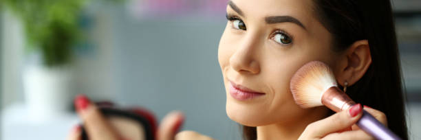 istock Young smiling beautiful brunette woman make her face up 1090982238
