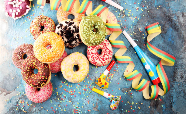 istock assorted donuts with chocolate frosted, pink glazed and sprinkles donuts 1090982254
