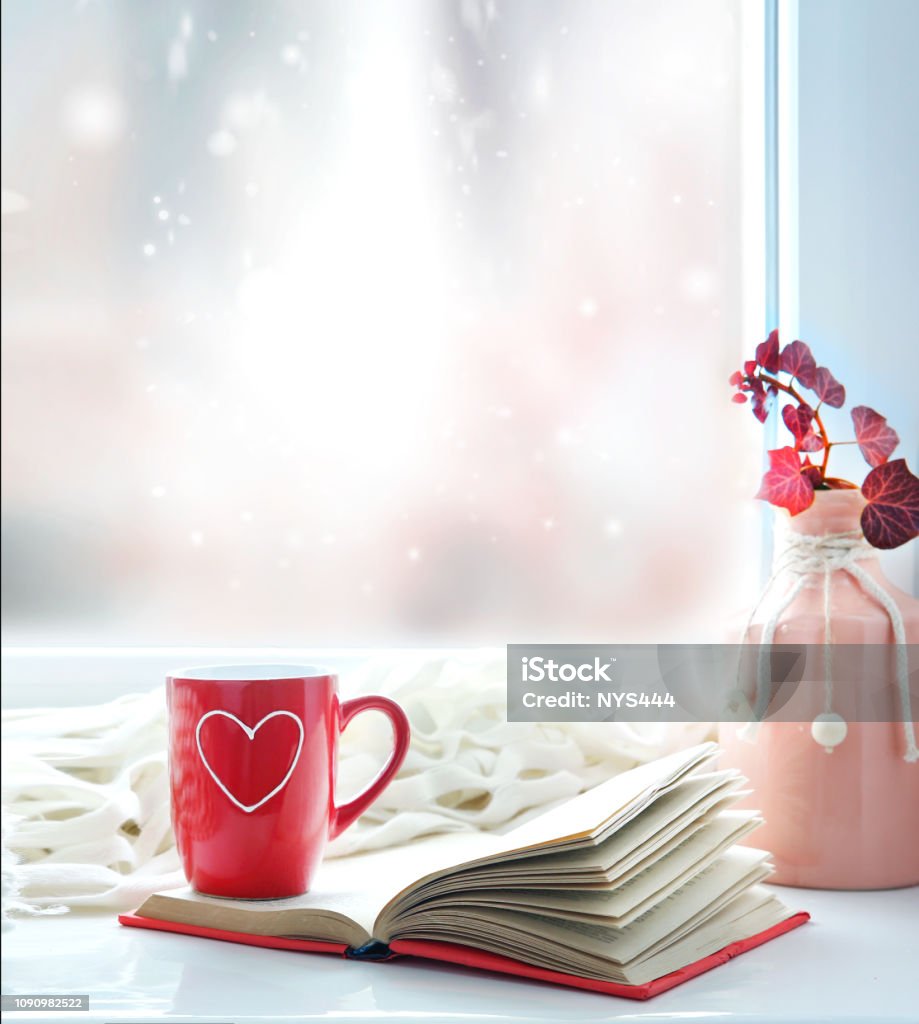 Valentine's day background,red mug on window still. Valentine's day background.Red mug with heart on window still empty copy space backdrop. February Stock Photo