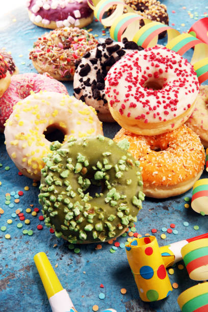 istock assorted donuts with chocolate frosted, pink glazed and sprinkles donuts 1090982582