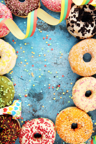 istock assorted donuts with chocolate frosted, pink glazed and sprinkles donuts 1090983480