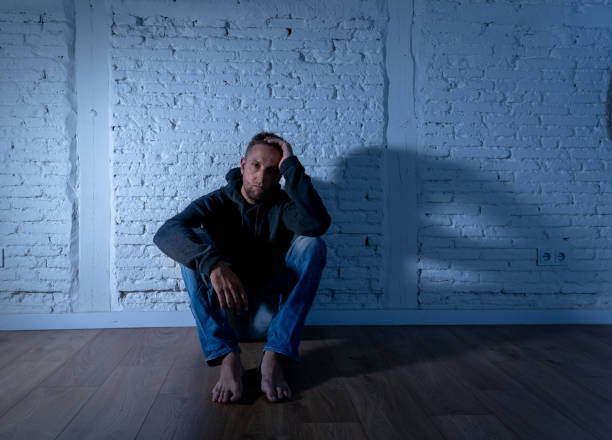 istock Young devastated depressed man crying sad feeling hurt suffering Depression in Sadness Emotional pain and human expression Loneliness and Heartbroken concept with copy space and dark mood light. 1090985042