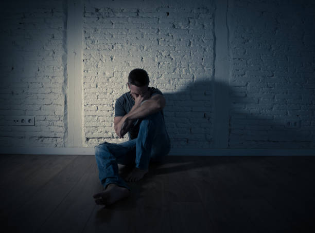 istock Young devastated depressed man crying sad feeling hurt suffering Depression in Sadness Emotional pain and human expression Loneliness and Heartbroken concept with copy space and dark mood light. 1090985058