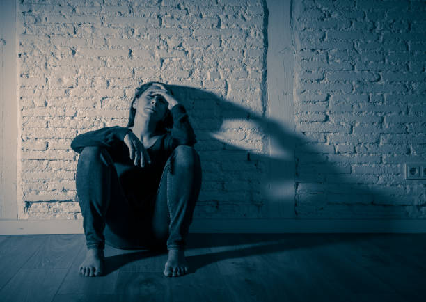 istock Young devastated depressed woman crying feeling hurt suffering depression in Sadness Emotional pain and Human Expression and Loneliness and heartbroken concept with copy space and dramatic dark light. 1090985950
