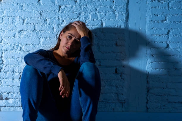 istock Young devastated depressed woman crying feeling hurt suffering depression in Sadness Emotional pain and Human Expression and Loneliness and heartbroken concept with copy space and dramatic dark light. 1090986052