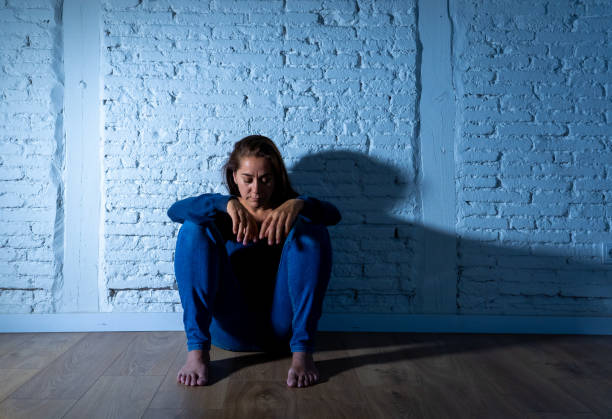 istock Young devastated depressed woman crying feeling hurt suffering depression in Sadness Emotional pain and Human Expression and Loneliness and heartbroken concept with copy space and dramatic dark light. 1090986080