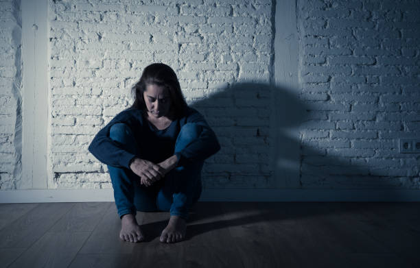 istock Young devastated depressed woman crying feeling hurt suffering depression in Sadness Emotional pain and Human Expression and Loneliness and heartbroken concept with copy space and dramatic dark light. 1090986242