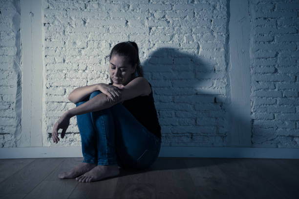 istock Young devastated depressed woman crying feeling hurt suffering depression in Sadness Emotional pain and Human Expression and Loneliness and heartbroken concept with copy space and dramatic dark light. 1090986266