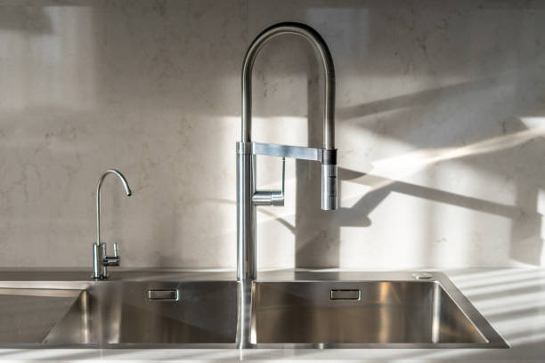 istock Close up photo of two water tap on kitchen with elegance modern interior 1090986592