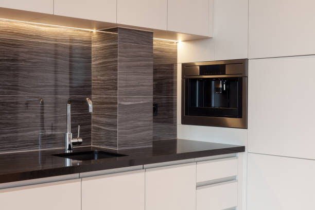 istock New modern kitchen with built in oven and chrome water tap. LED worktop illumination 1090990662