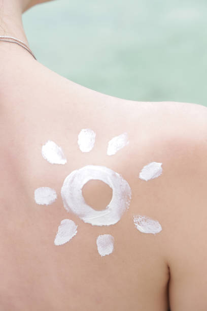 istock Woman with sun shaped sunscreen on her shoulder 1090992522