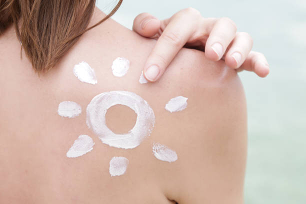 istock Woman with sun shaped sunscreen on her shoulder 1090992652