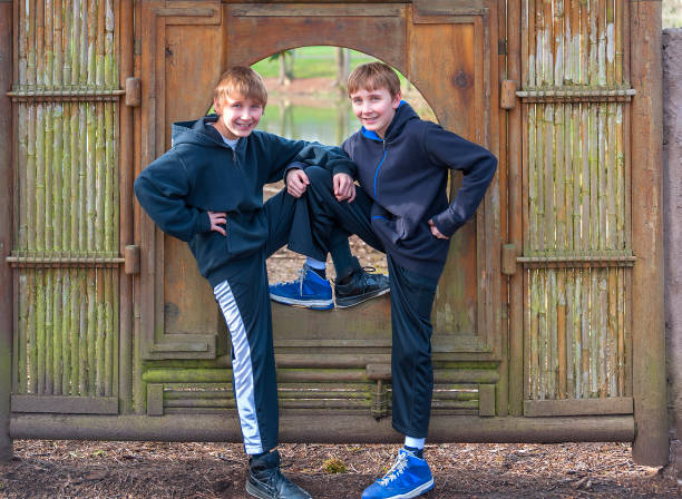 istock Two Boys posing in a bamboo frame in a Public Park 1091005750