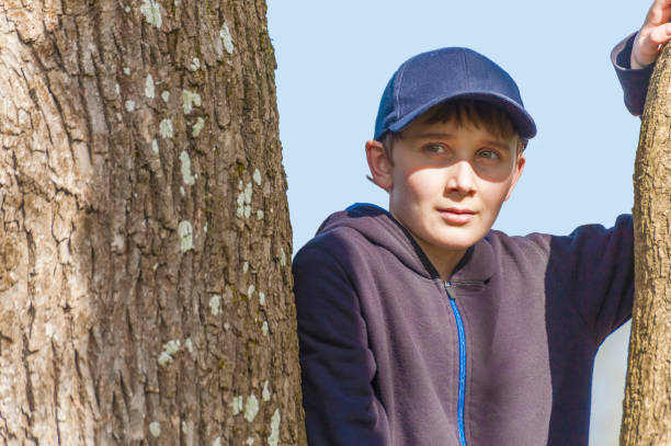 istock Close up of a young boy in a tree 1091005856