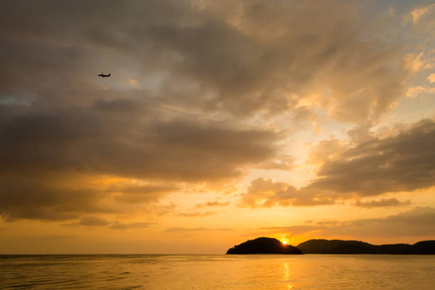 Pantai Cenang beach on tropical Langkawi island in Malaysia. Beautiful nature of south east asia during colorful sunset.