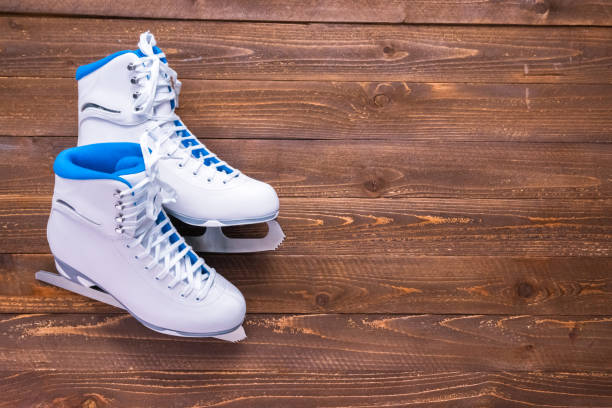 istock New white figure skates on a wooden boards. 1091017624