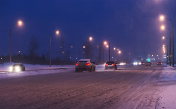 istock Cars drive along snow-covered road. 1091024248