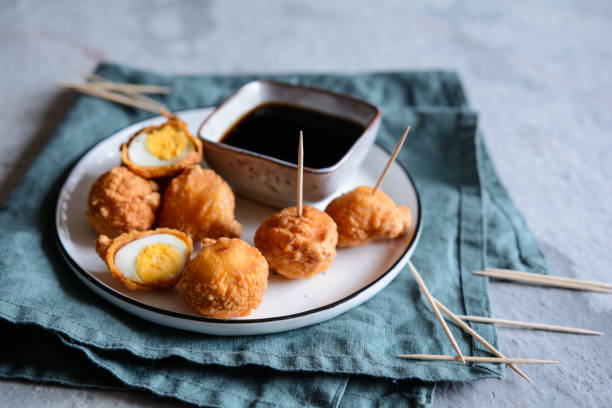 Kwek Kwek - deep fried quail eggs coated with batter served with soya sauce and vinegar dip Kwek Kwek - traditional deep fried quail eggs coated with batter served with soya sauce and vinegar dip quail egg stock pictures, royalty-free photos & images