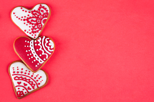 Valentine's heart cookies on red background. The cookies are homemade made by me and are unique and can not be found anywhere.