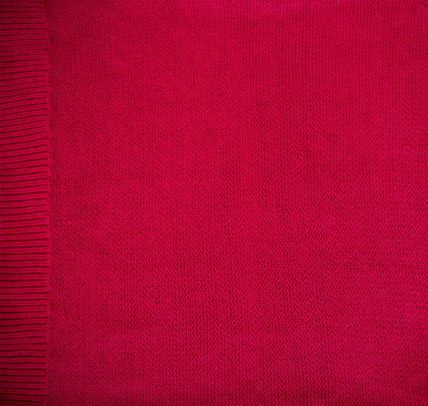 istock Red Knitted pattern wool sweater texture close up. Handmade red knitting wool texture background 1091030944