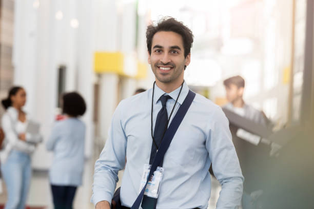 istock Male high school teacher walks down school hallway 1091032390