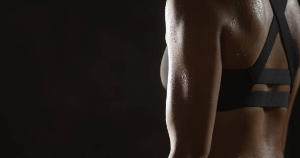 istock Active Chinese woman lifting dumbbells weights and sweating 1091032522