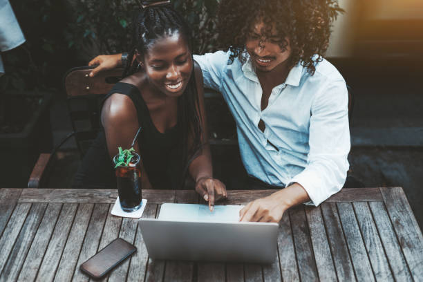 istock Cheerful interracial couple with laptop in cafe 1091037064