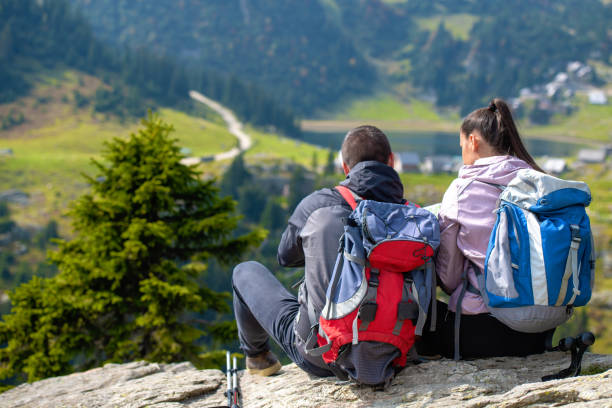 istock Smiling adventure couple with map on slope. look at map 1091038182