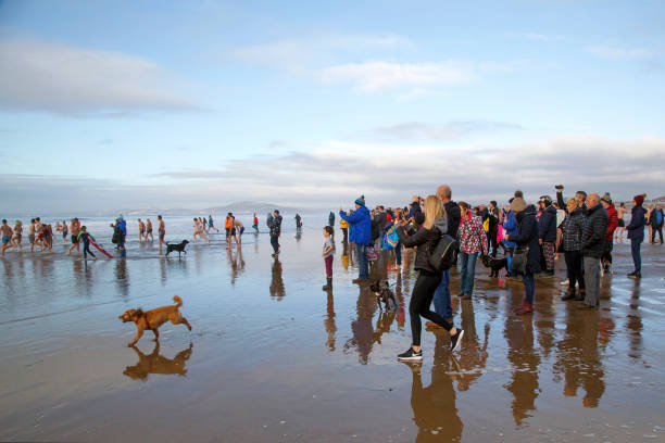 New Year's Day Fancy Dress Swim - UK Aberavon, Wales, UK: January 01, 2019: Spectators watch as people swim in the freezing cold sea during a New Year's Day Polar Swim. Some are in fancy dress and any money raised go to a local charity. 2019 new year resolution stock pictures, royalty-free photos & images