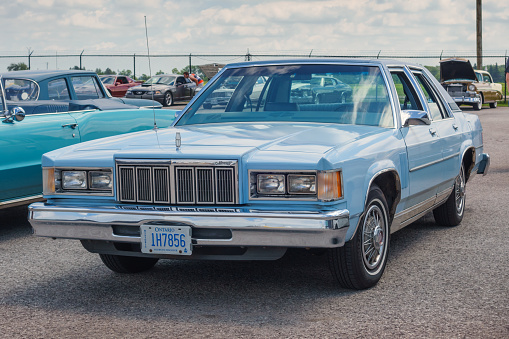 A blue colored, 1979 Mercury Marquis with Ontario license plate is parked in a parking lot in Hamilton, Ontario, Canada