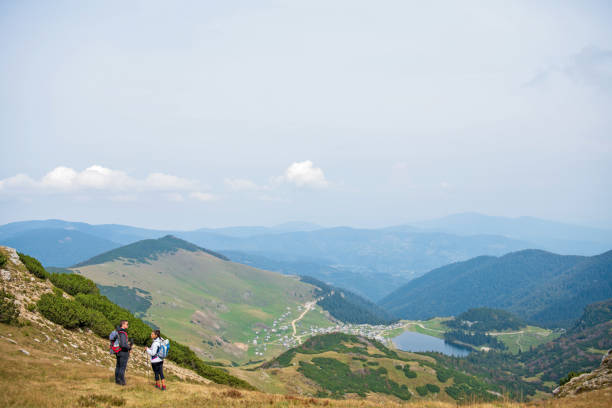 istock Sporty hikers on path with trekking poles 1091047822