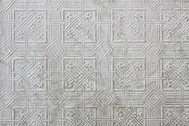 Textured pattern in pressed tin with pale green imperfections